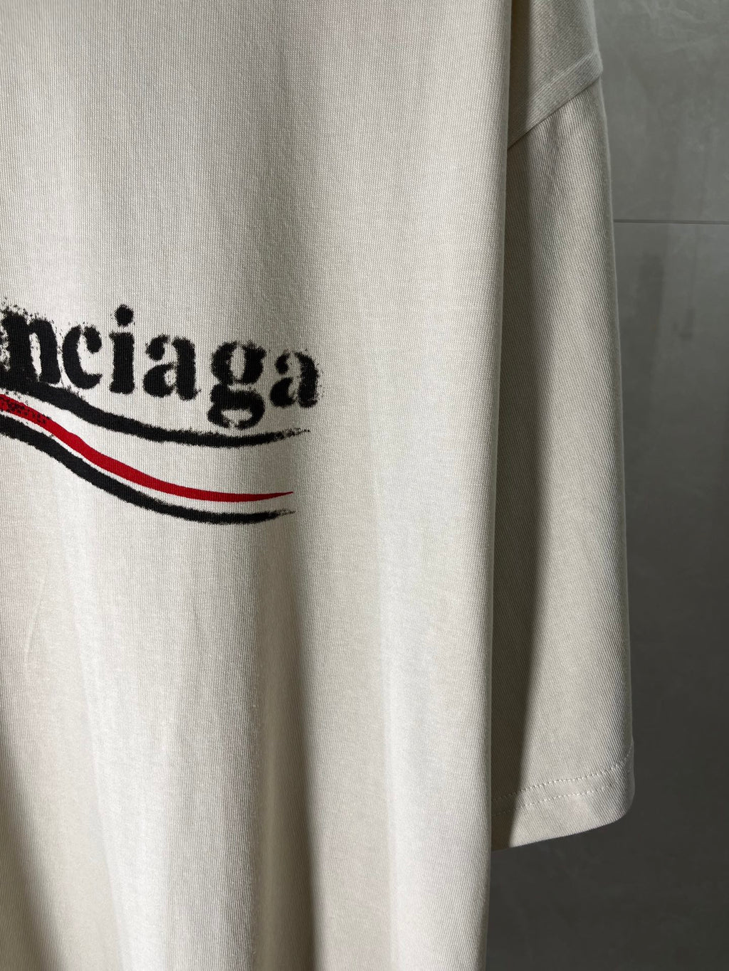 Balenciaga light cream T-shirt front panel with logo graphic and curved hem