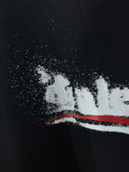 Black T-shirt with distressed white logo dots and red stripe detail