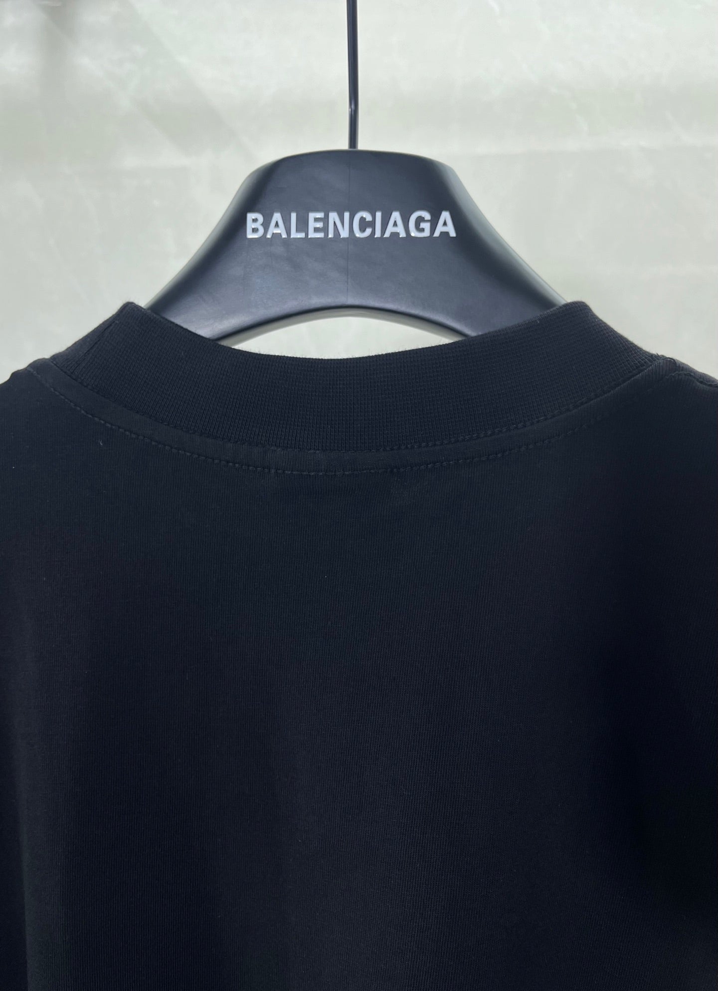 Black crew-neck T-shirt with short sleeves, plain back neckline