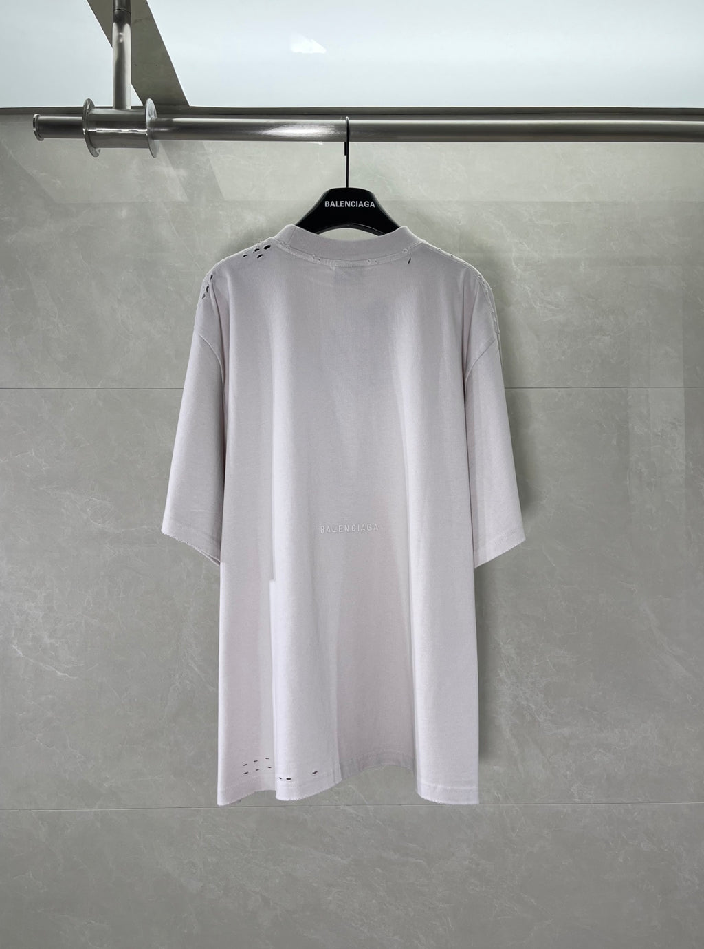 White Balenciaga T-shirt back view with small stitched details near shoulders