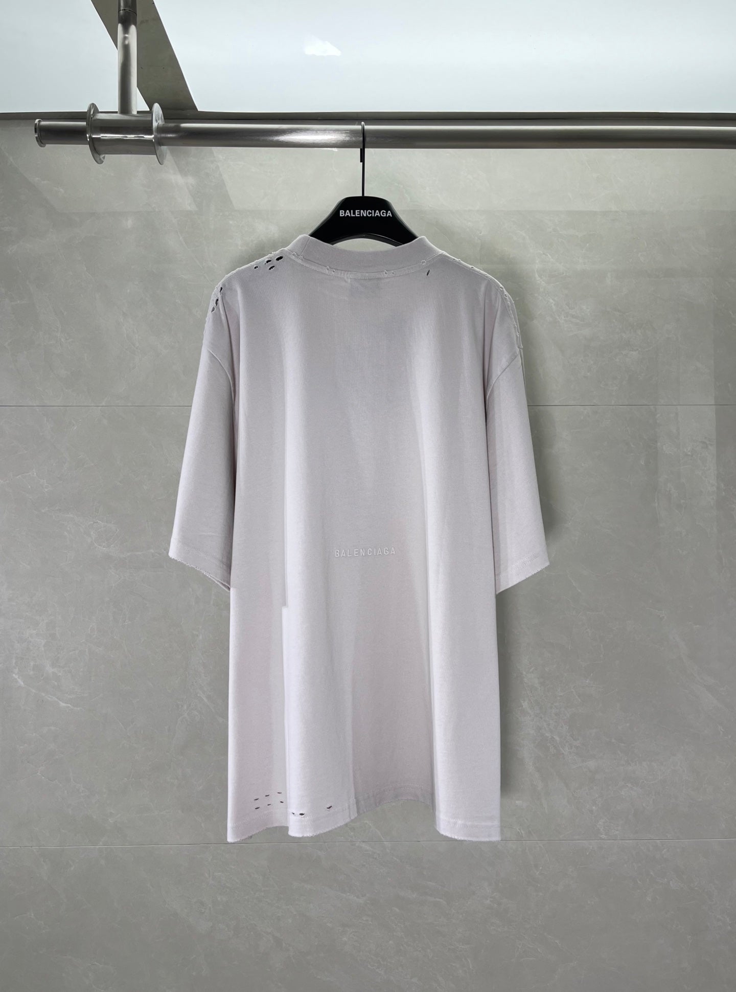 White Balenciaga T-shirt back view with small stitched details near shoulders