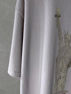 White Balenciaga T-shirt sleeve and side seam with partial statue graphic