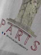 White Balenciaga T-shirt close-up with red PARIS text and Liberty illustration