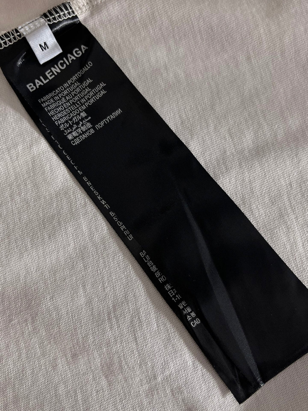 Balenciaga T-shirt size and care label on black garment tag