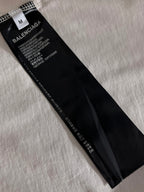 Balenciaga T-shirt size and care label on black garment tag