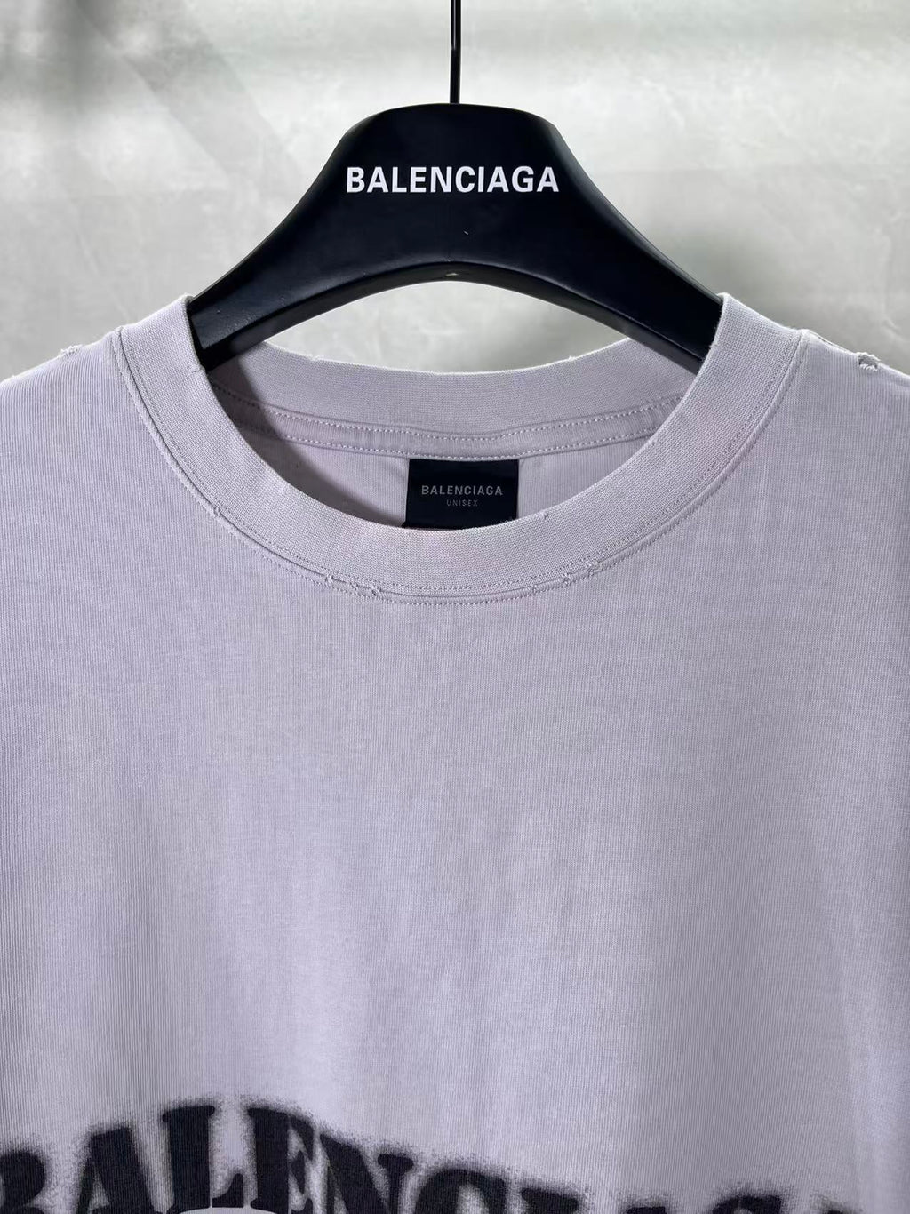 Light lavender Balenciaga T-shirt neckline close-up with small neck label