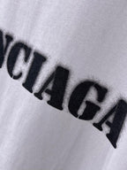 Light lavender Balenciaga T-shirt logo print close-up with bold black letters