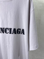 Light lavender Balenciaga T-shirt side hem with partial black logo lettering
