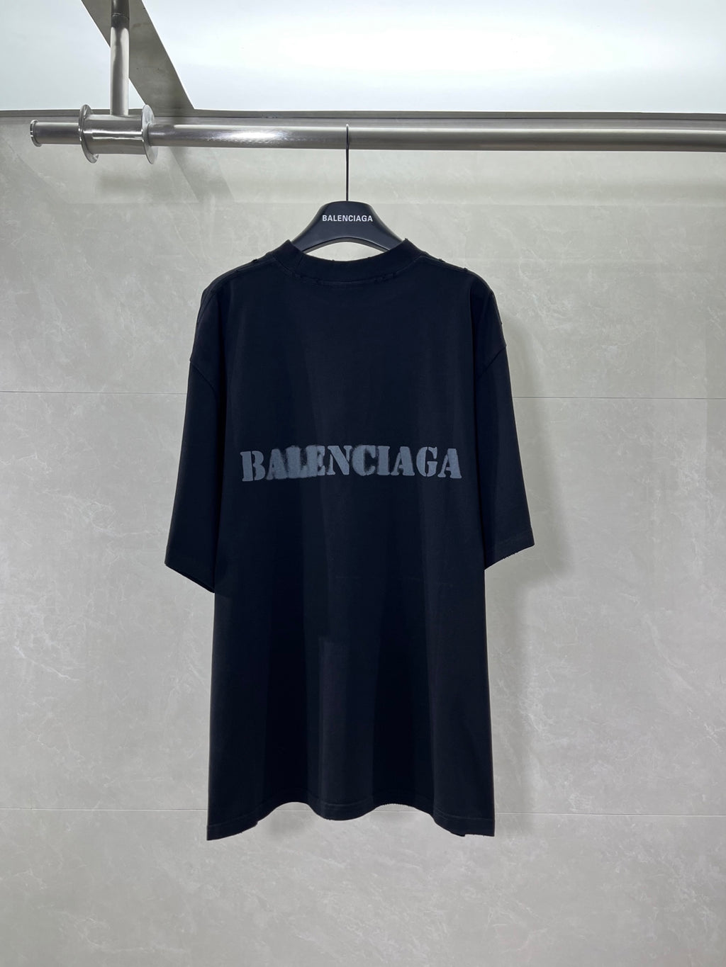 Dark short-sleeve T-shirt with BALENCIAGA logo at chest.