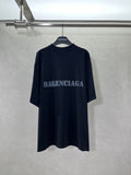 Dark short-sleeve T-shirt with BALENCIAGA logo at chest.