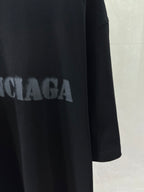 Dark T-shirt with partial BALENCIAGA lettering across front.