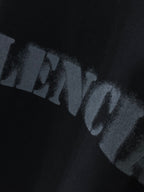 Distressed BALENCIAGA logo print on dark T-shirt fabric.