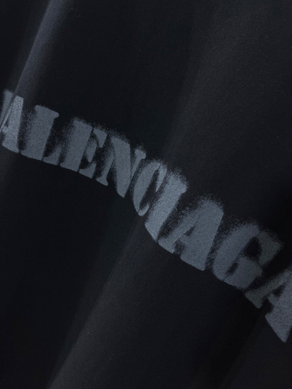 Dark T-shirt with BALENCIAGA logo print in distressed letters.
