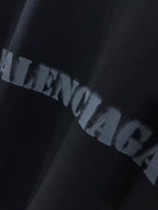Dark T-shirt with BALENCIAGA logo print in distressed letters.