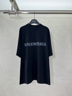 Dark oversized T-shirt with BALENCIAGA logo centered on front.