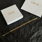 Gold chain bracelet with repeating links and Dior clasp