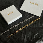 Gold chain bracelet with alternating links and Dior hoop clasp