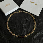 Dior gold-tone chain necklace laid flat with interlocking links