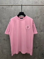 Pink short-sleeve T-shirt with small circular chest emblem