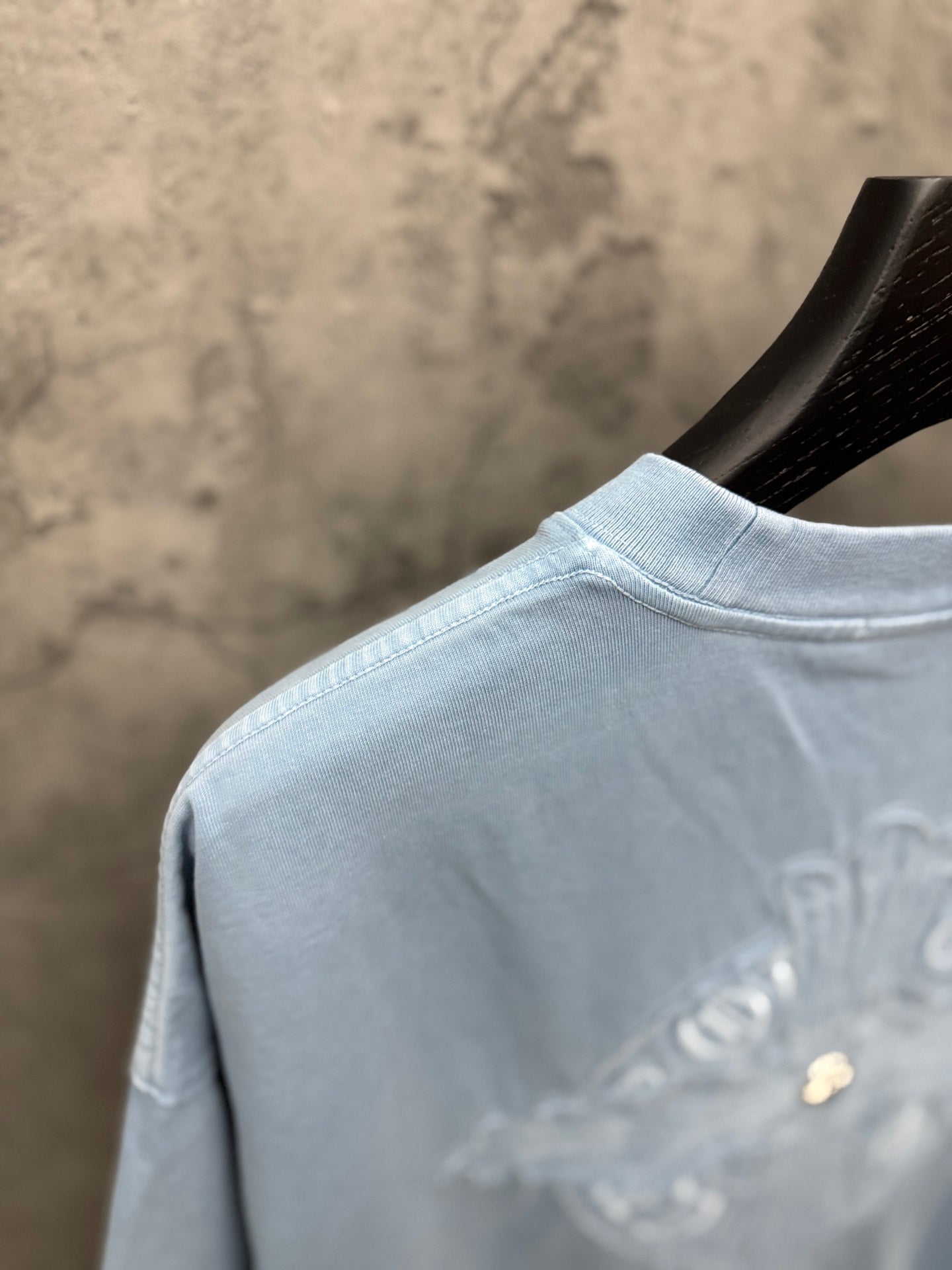 Light blue T-shirt neckline and partial back crest embroidery detail