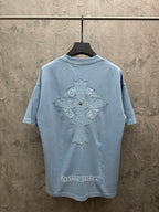 Light blue T-shirt, back view, with large crest graphic and decorative emblem