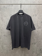 Dark gray crew-neck T-shirt with small circular embroidered chest crest