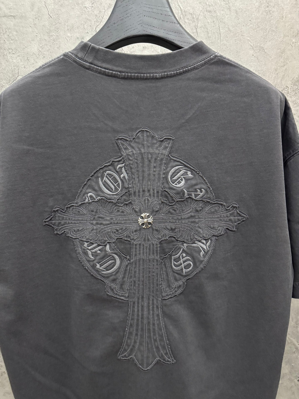 Dark gray T-shirt back with large winged cross embroidery crest