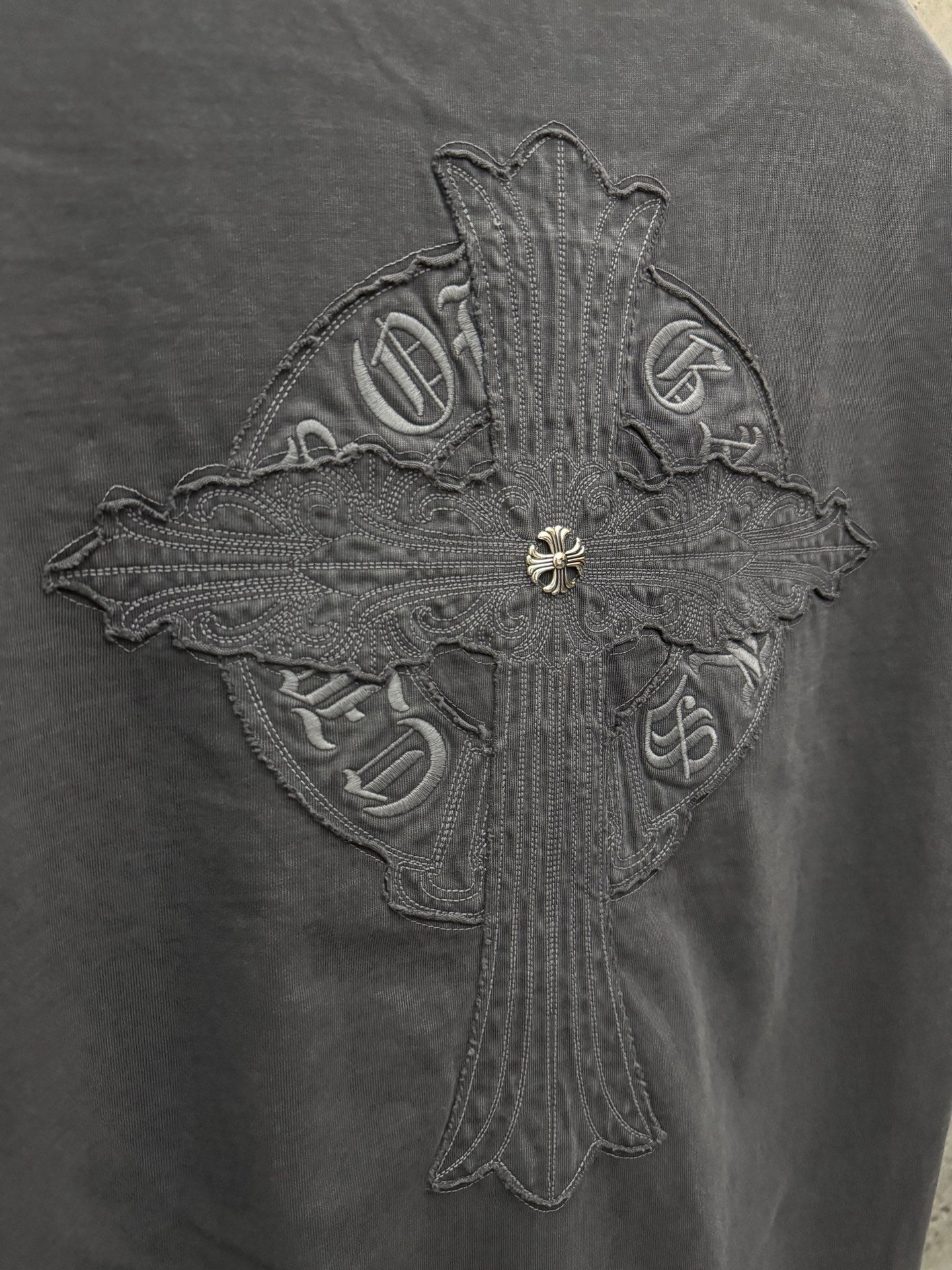 Dark gray T-shirt winged cross crest embroidery close-up