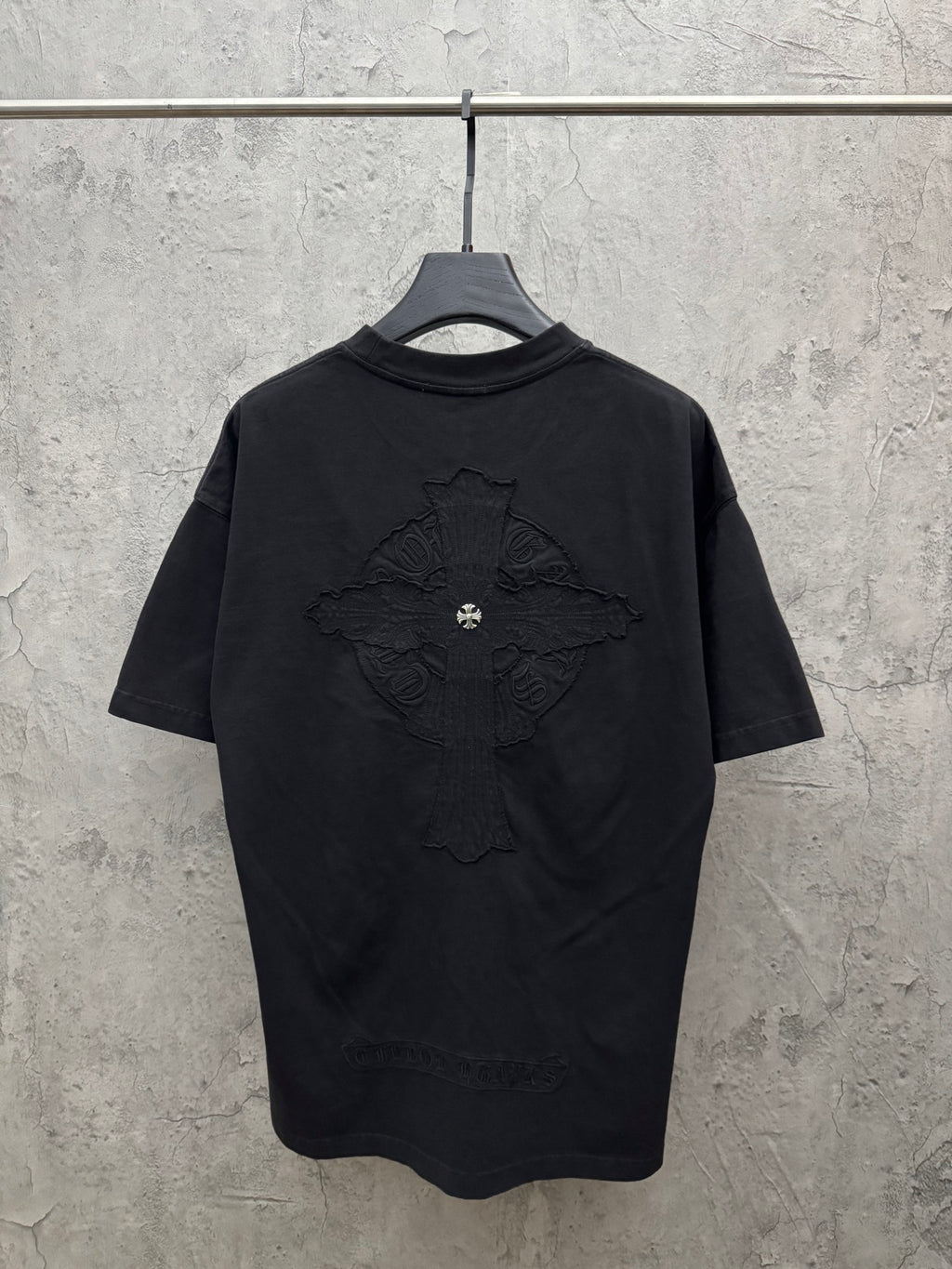 Dark crewneck short-sleeve T-shirt with large embroidered cross design on back