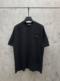 Crewneck short-sleeve T-shirt in dark color with small chest emblem patch
