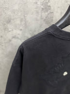 Dark short-sleeve crewneck T-shirt with small embroidered logo on shoulder/back