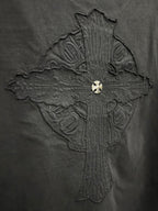 Close-up of embroidered cross graphic on dark T-shirt back