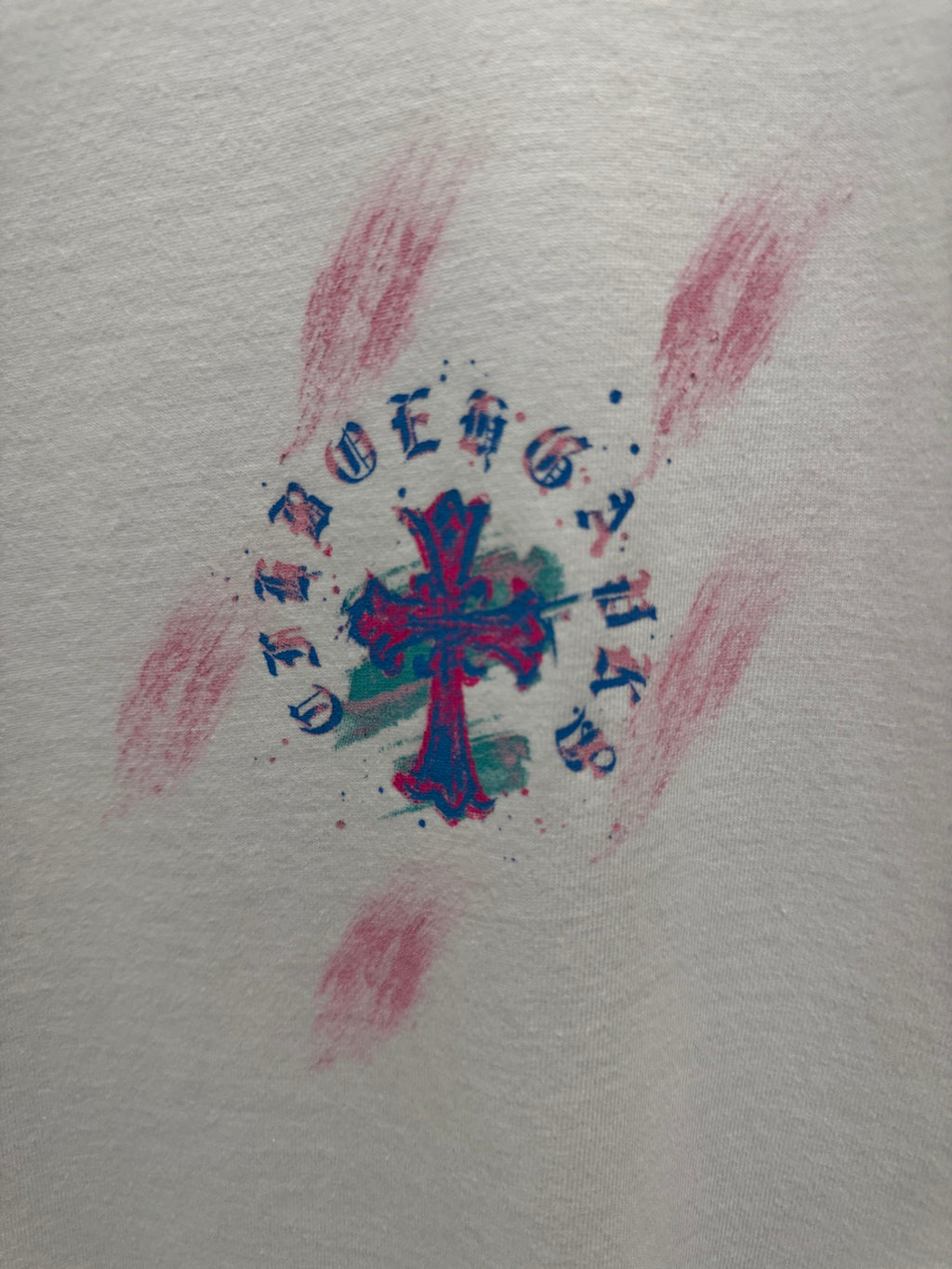 White T-shirt fabric with colorful cross graphic and musical notes