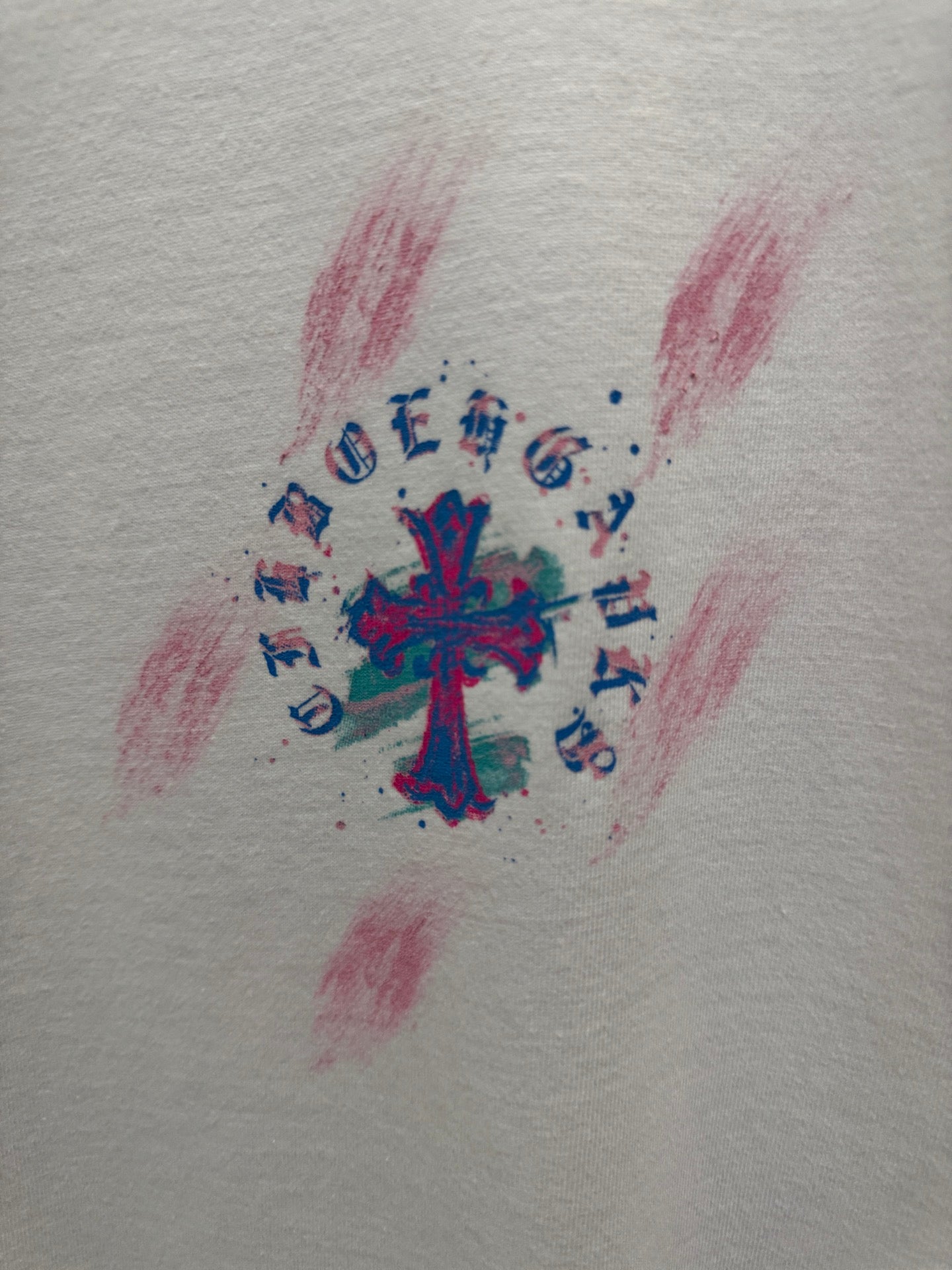 White T-shirt fabric with colorful cross graphic and musical notes