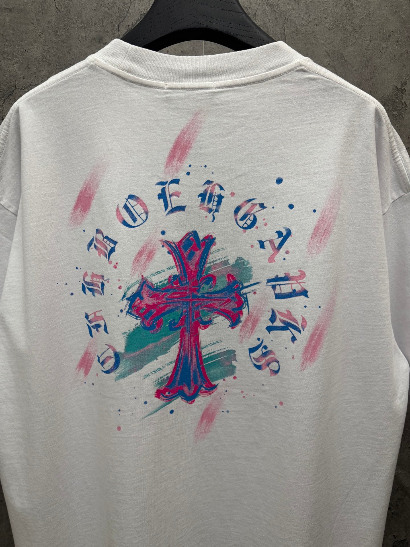 White T-shirt with large colorful back cross graphic and music characters