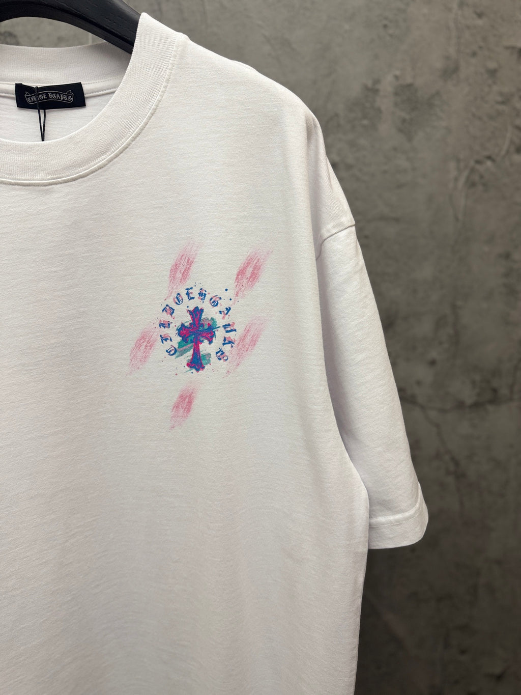 White T-shirt showing short sleeves and small chest graphic