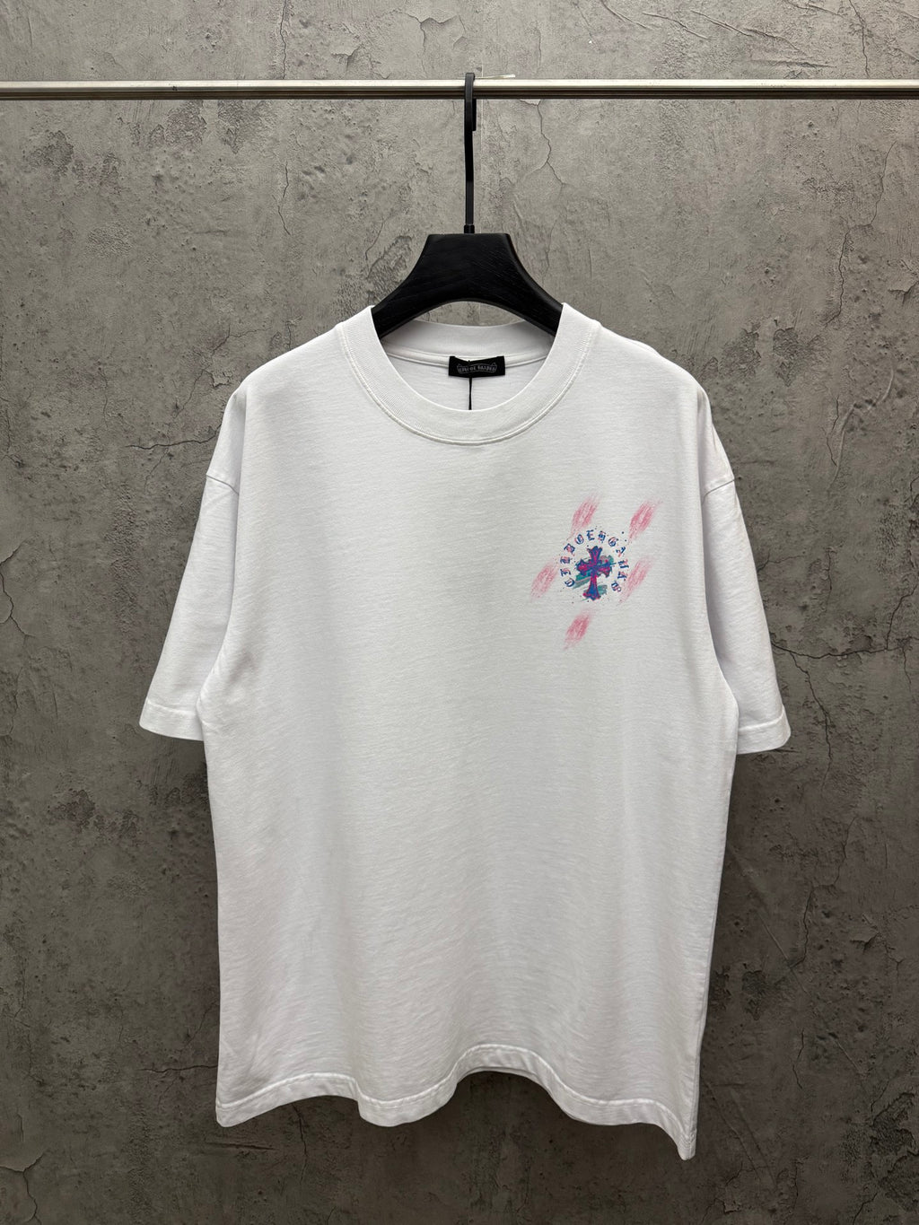 White graphic T-shirt with colorful cross-style front print