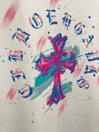 White T-shirt close-up of colorful cross graphic with note symbols