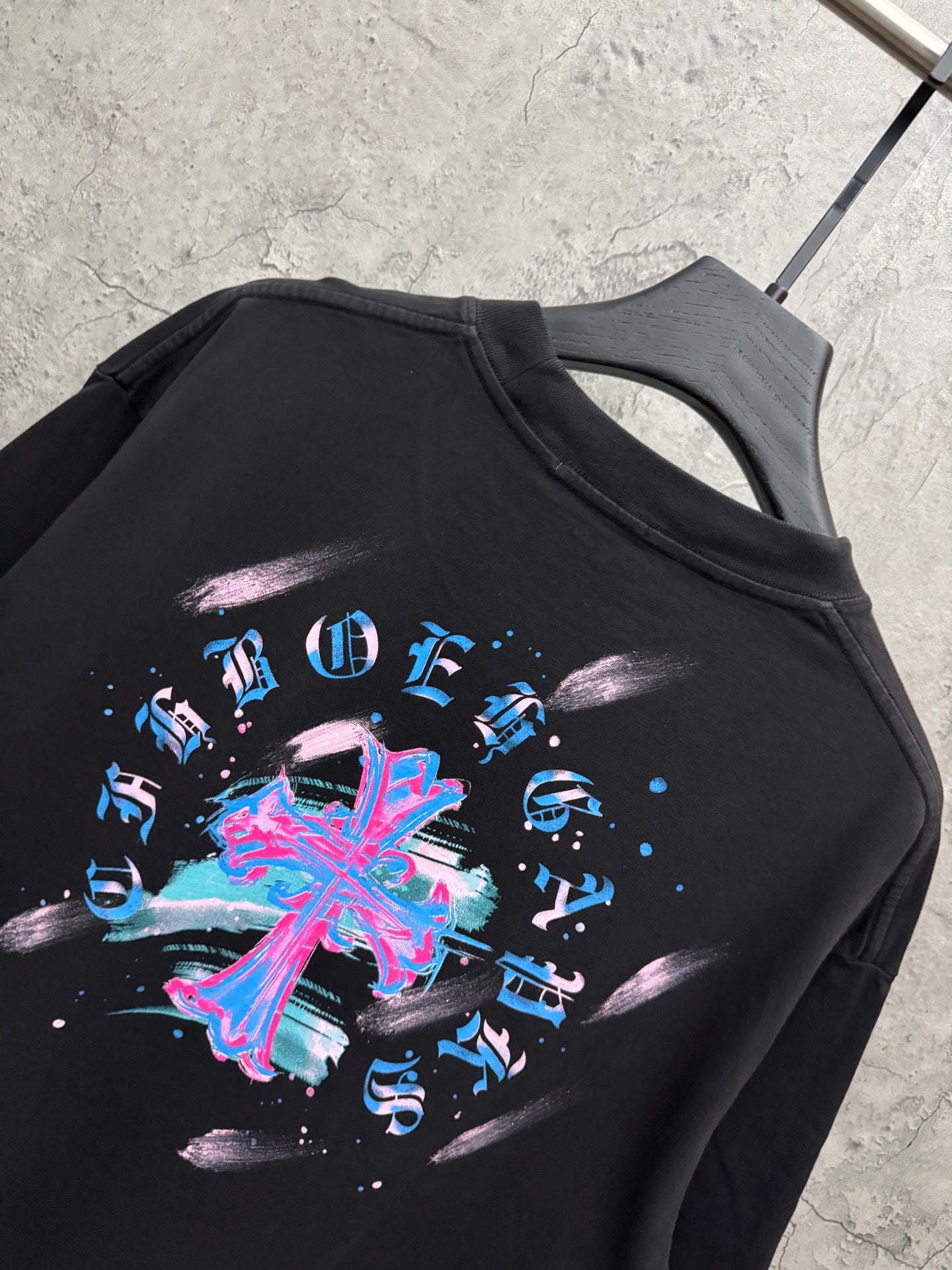 Black short-sleeve T-shirt with large neon music graphic across back