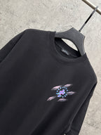Black short-sleeve T-shirt with crew neck and small neon music graphic