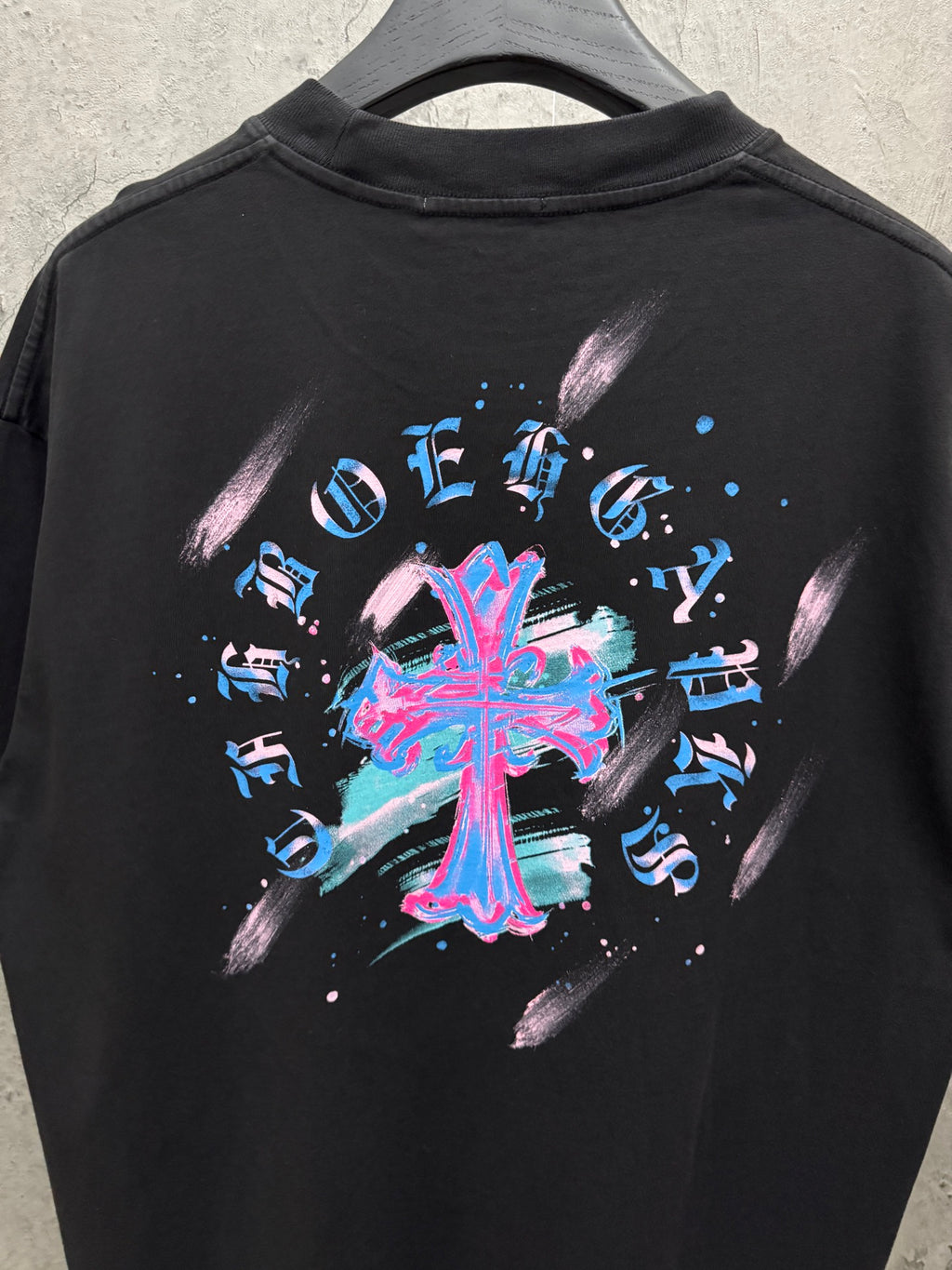 Black short-sleeve T-shirt with oversized neon music graphic on back