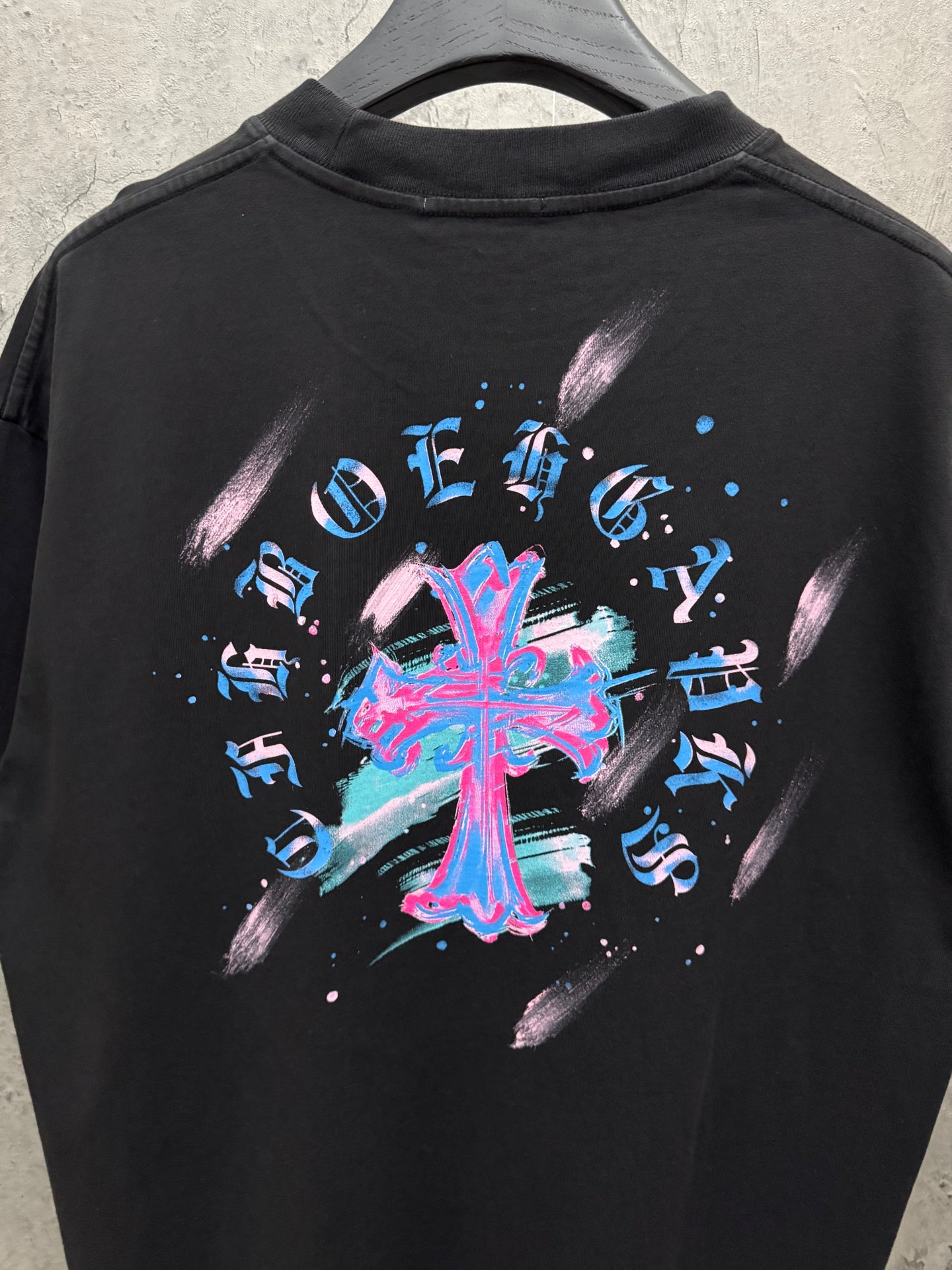 Black short-sleeve T-shirt with oversized neon music graphic on back