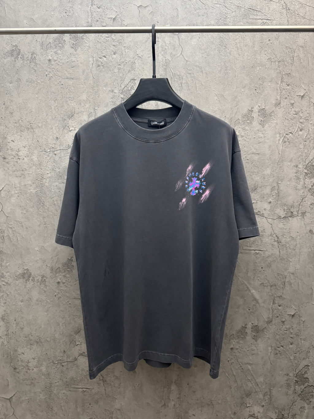 Dark gray short-sleeve T-shirt with small colorful cross graphic at chest