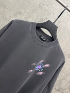 Dark gray T-shirt close-up of crew neck and small colorful cross graphic