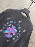Dark gray short-sleeve T-shirt close-up with large colorful cross graphic on back