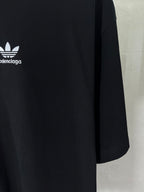 Short-sleeve T-shirt fabric and side seam close-up with partial logo