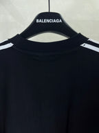 Short-sleeve T-shirt neckline close-up in dark fabric with small logo