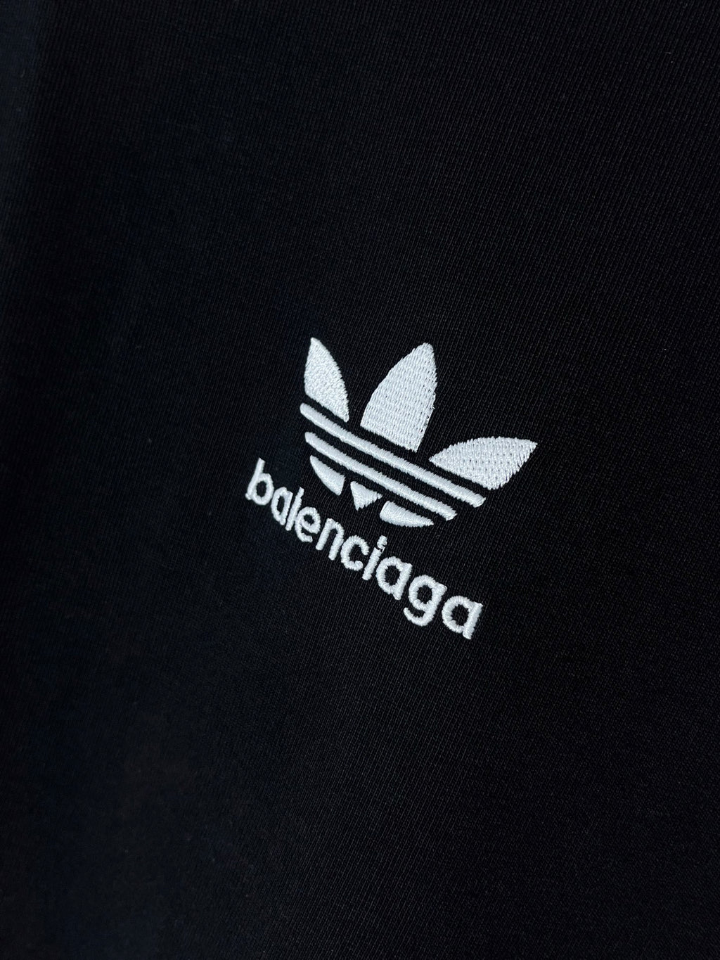 Short-sleeve T-shirt chest logo close-up with adidas-style emblem