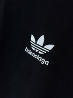 Short-sleeve T-shirt chest logo close-up with adidas-style emblem