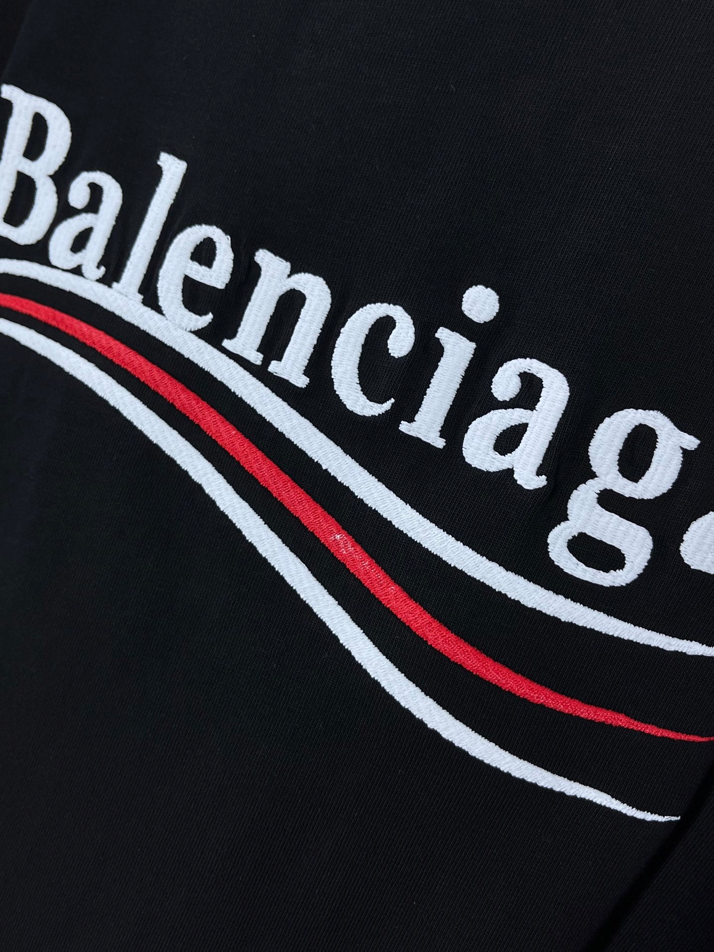 Balenciaga graphic logo detail on black T-shirt fabric
